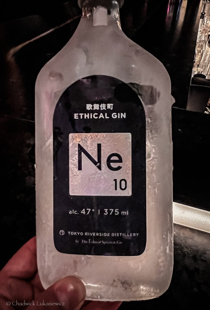 Close-up of a frosted bottle of Ne10 Ethical Gin from Tokyo Riverside Distillery, with a label resembling the periodic table, showing 47% alcohol by volume in a 375 ml bottle.