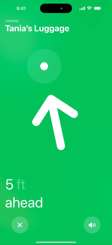 A bright green screen on the Find My app showing the precise location of an item labeled “Tania’s Luggage” with a large white arrow pointing forward and text reading “5 ft ahead.”