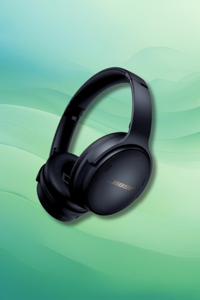 A pair of black Bose QuietComfort 45 headphones displayed against a soft green gradient background. The headphones are tilted slightly, showcasing their cushioned ear cups and headband.