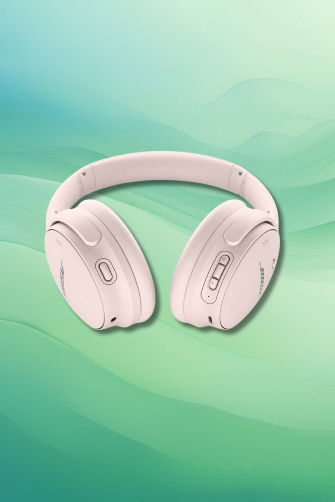 White Bose QuietComfort 45 headphones displayed on a soft green gradient background. The image emphasizes the clean design, including control buttons on the ear cups and the smooth texture of the headphones.