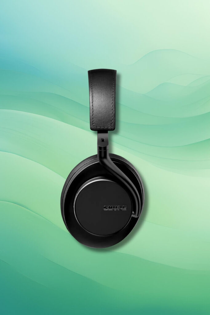 A single black Shure AONIC 50 Gen 2 headphone displayed upright against a soft green gradient background. The headphone’s ear cup prominently features the “Shure” logo, while the headband extends vertically above.