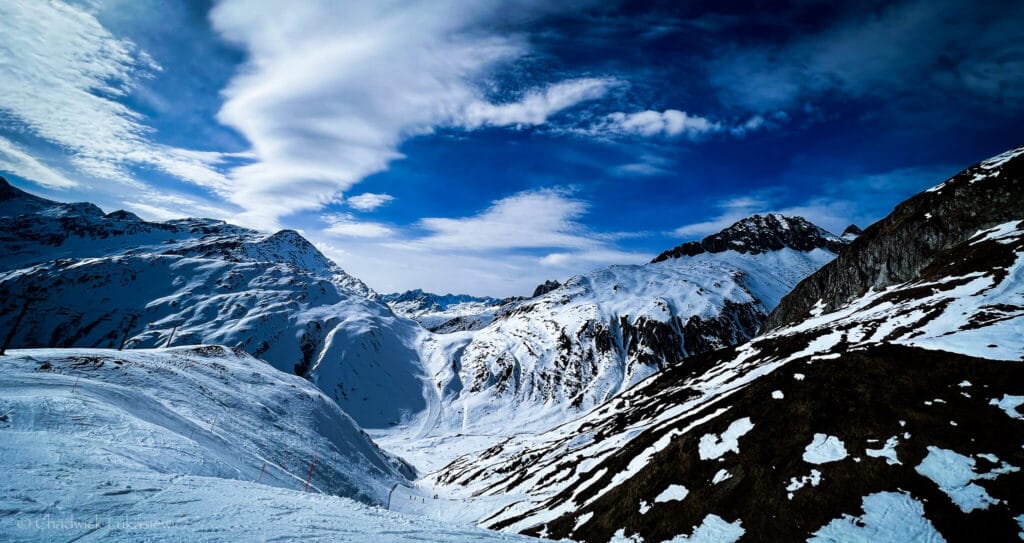 Snow-covered peaks of Andermatt, Switzerland, captured in crisp detail, illustrating ADHD travel photography’s focus on sensory experiences