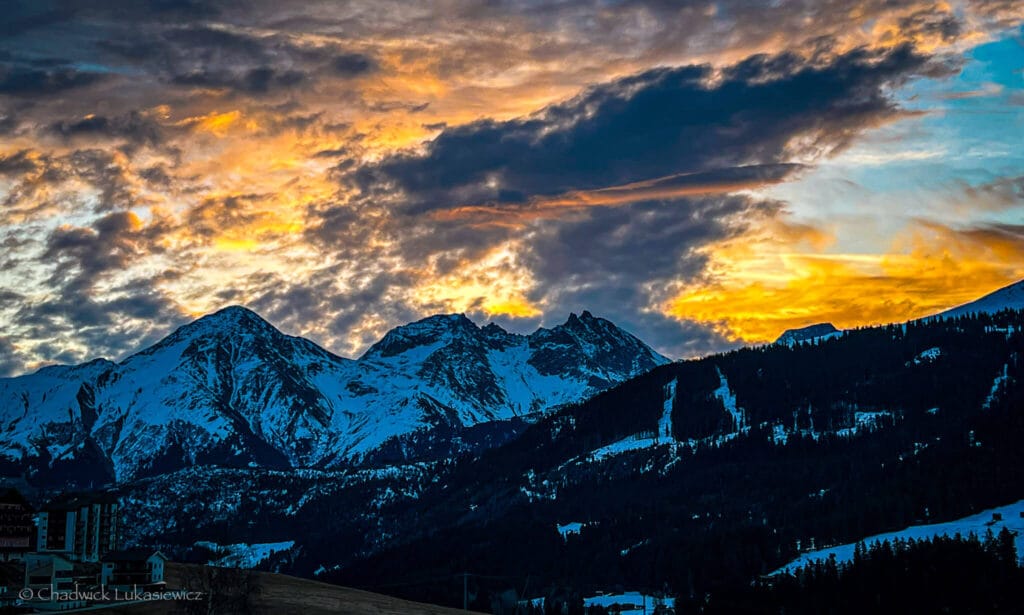 Golden sunrise over the snow-capped peaks of Sedrun, Switzerland, capturing the intensity of ADHD hyperfocus in travel photography.