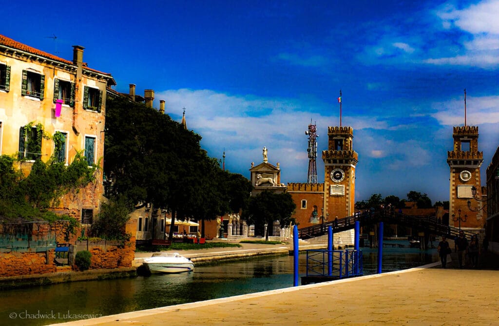 The Arsenale di Venezia canal reflecting historic architecture in warm sunlight, showcasing mindful travel photography techniques for ADHD creatives.