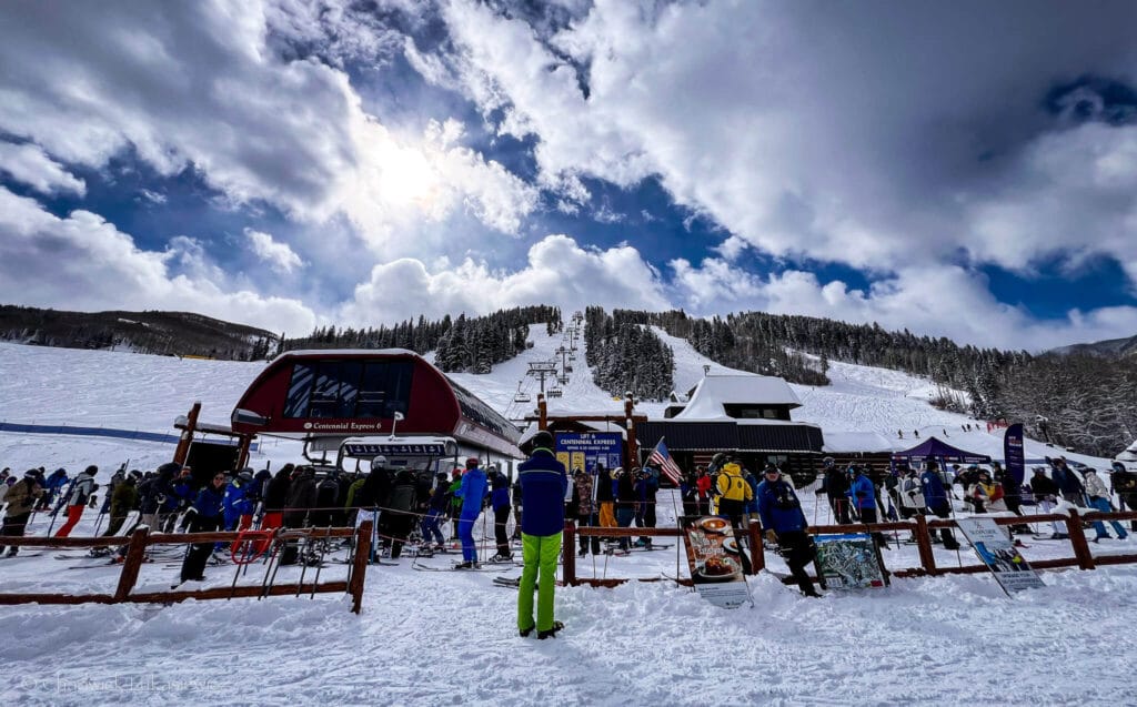 Skiers awaiting Centennial Express at Beaver Creek under blue skies, introducing a guide to sensory-friendly Colorado ski resorts.