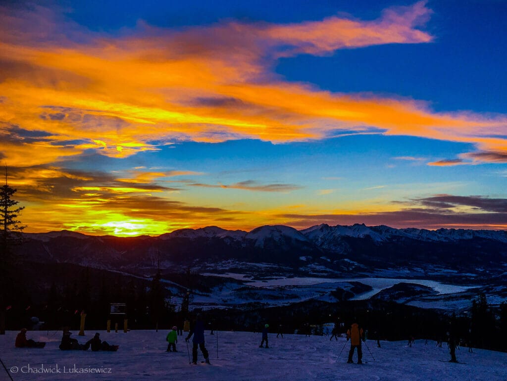 Fiery sunset skies over Keystone’s Schoolmarm during night skiing, showcasing the best times to ski in Colorado without crowds.