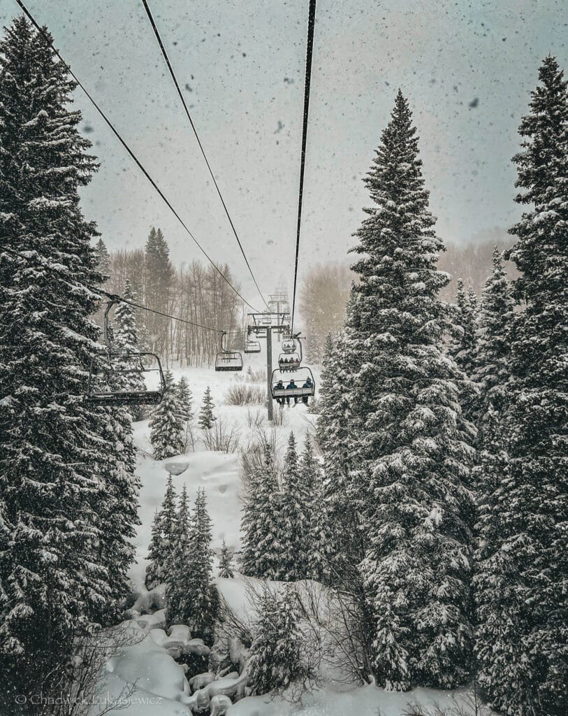Strawberry Park Express lift among snow-laden evergreens at Beaver Creek, a sensory-friendly mountain escape in Colorado.